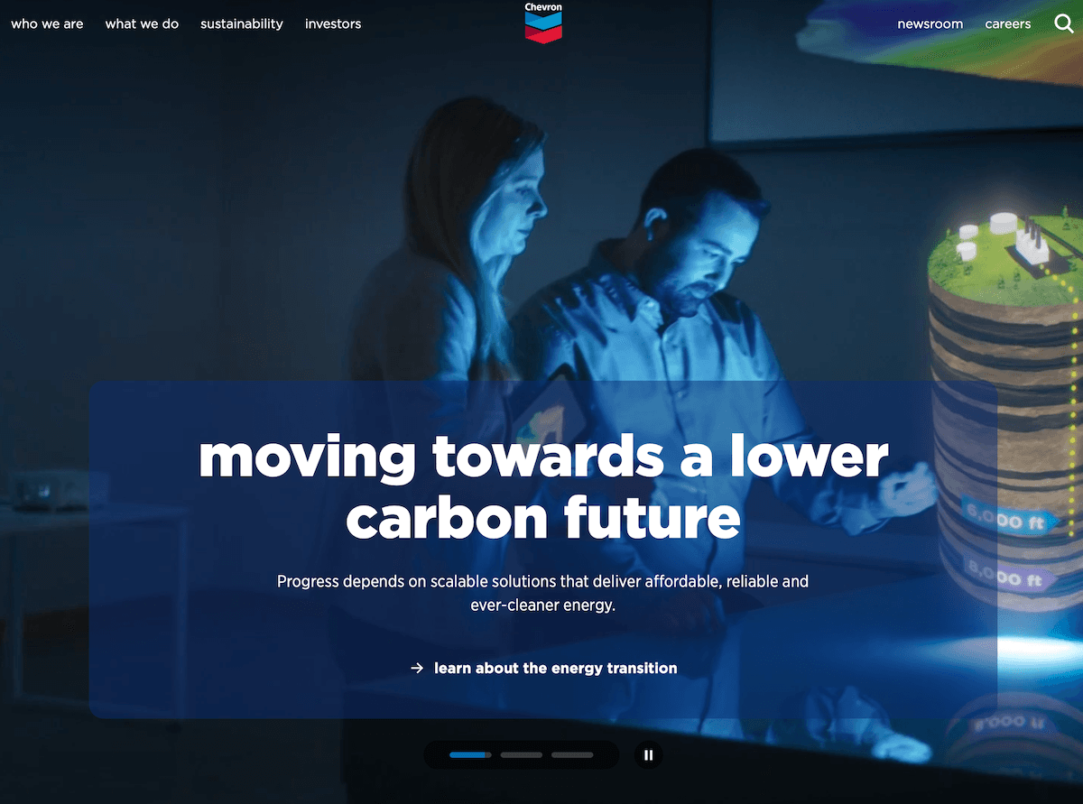 A look at Chevron's homepage hero, where a male and female engineer look at a 3D rendering of an oil site. The copy says "Moving towards a lower carbon future."